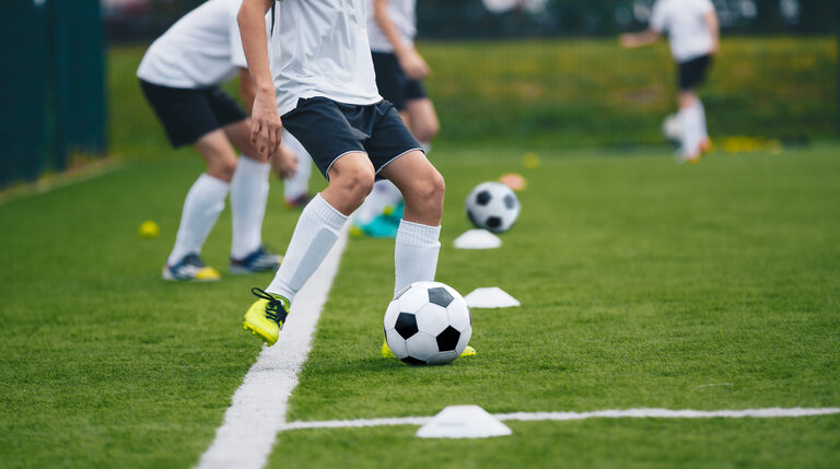 Soccer player kicking a soccer ball in practice